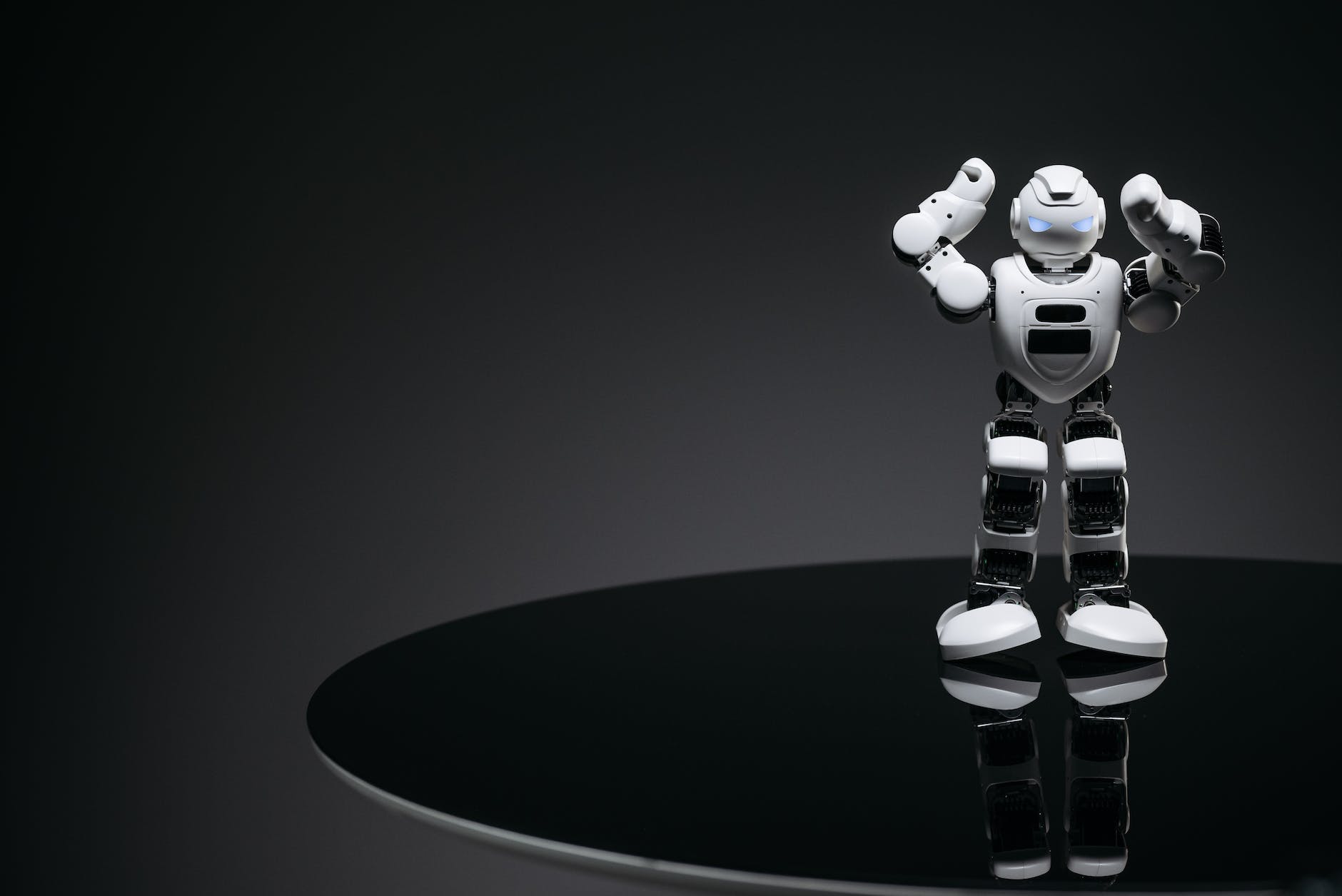 white robot toy on round black table